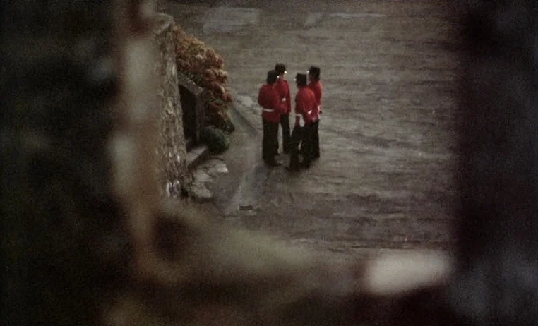 The Story of Adele H (1975) movie still: wide — A stone-paved courtyard is seen from an elevated position through an obscured stone opening. Four…