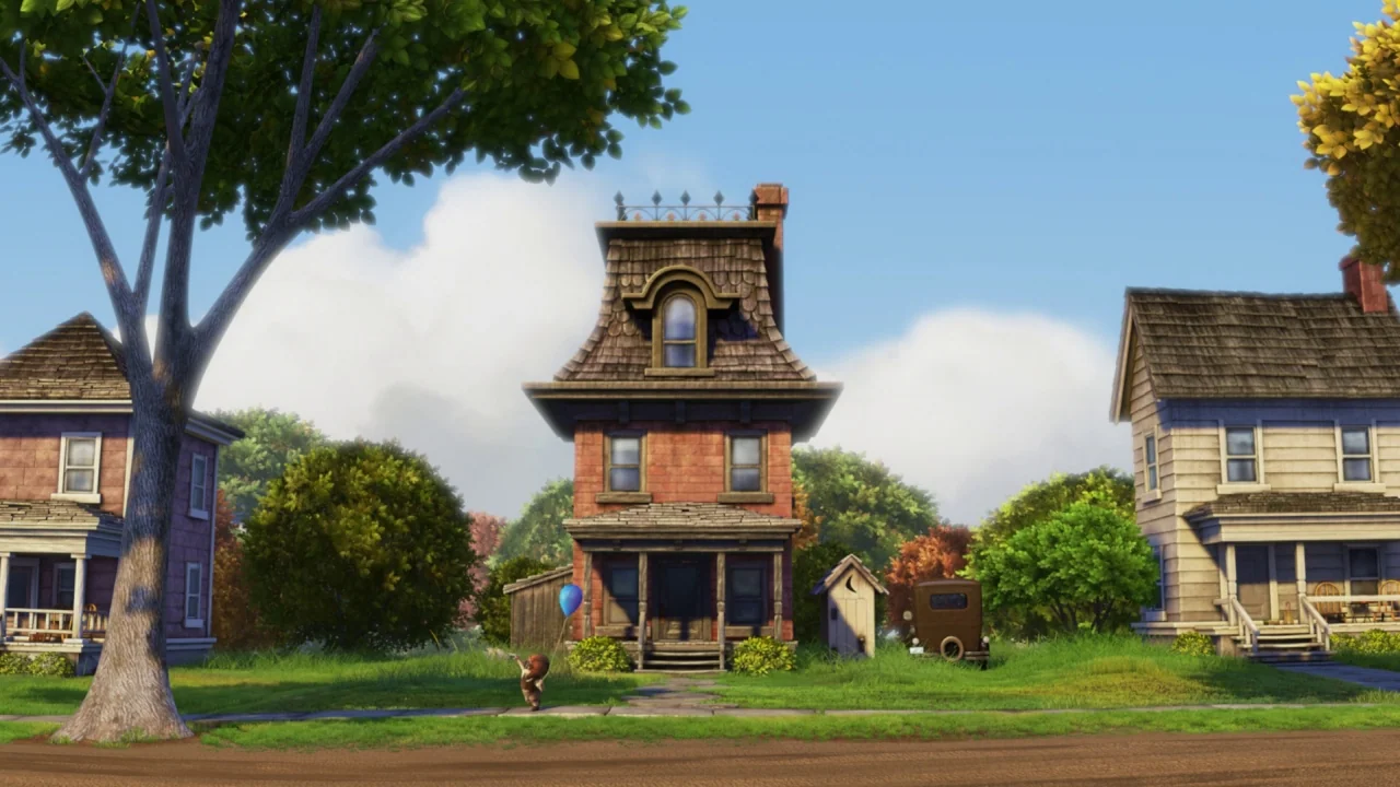 Up (2009) movie still: wide — A suburban street scene features a distinct tall red brick house with a mansard roof. Green trees and smaller wooden…