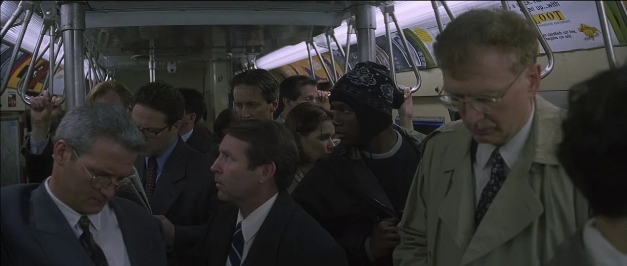 Finding Forrester (2000) movie still: medium — A crowded public transit subway car interior with rows of vertical silver metal handrails. Several…