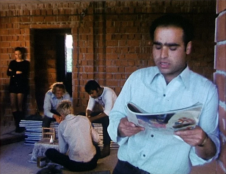 The Niklashausen Journey (1970) movie still: medium — An unfinished room features exposed red brick walls and a floor with scattered construction…