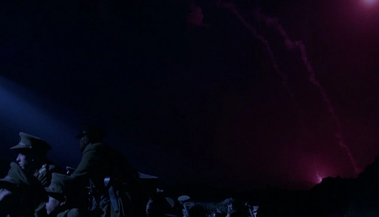 Legends of the Fall (1994) movie still: medium — A dark, earth-walled military trench at night under a red-lit sky. Several soldiers in uniform…