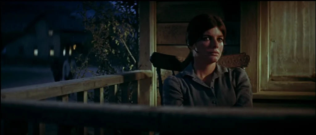 Butch Cassidy and the Sundance Kid (1969) movie still: medium — A dark, wooden porch at night with railings and a blurred building in the…