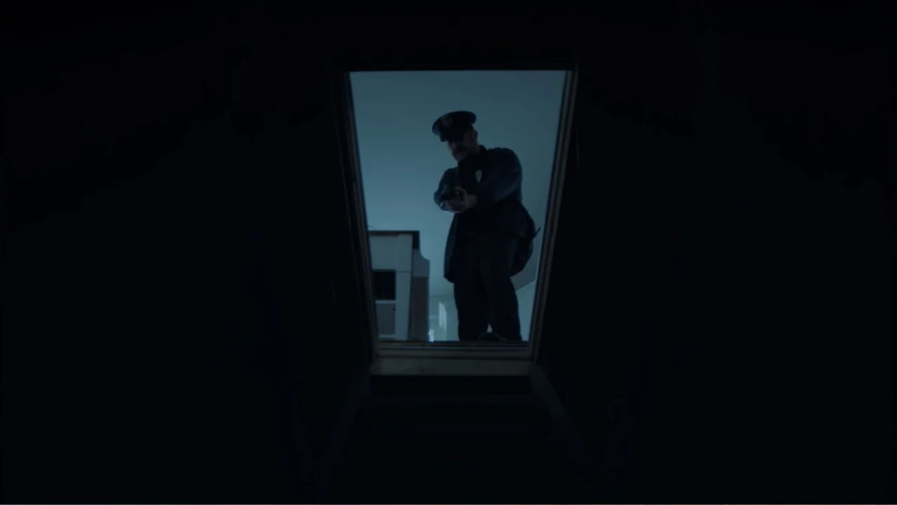 Storm Damage (2000) movie still: medium — A dark, narrow staircase looking up toward a brightly lit doorway at the top. A male police officer in…