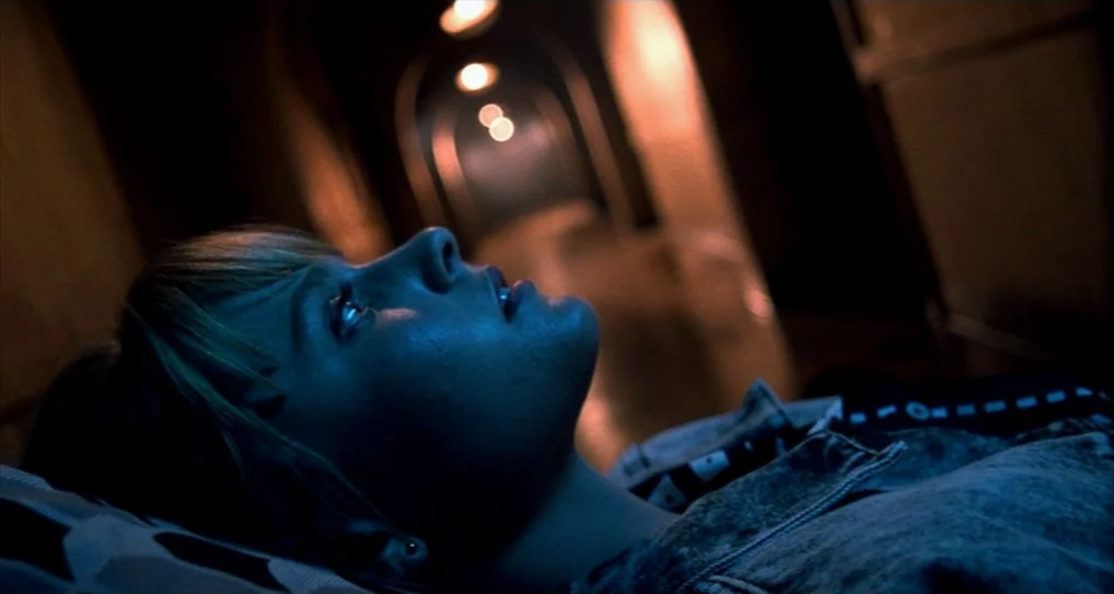 A Nightmare On Elm Street 5: The Dream Child (1989) movie still: closeup — A dark hallway features a succession of receding arched doorways…