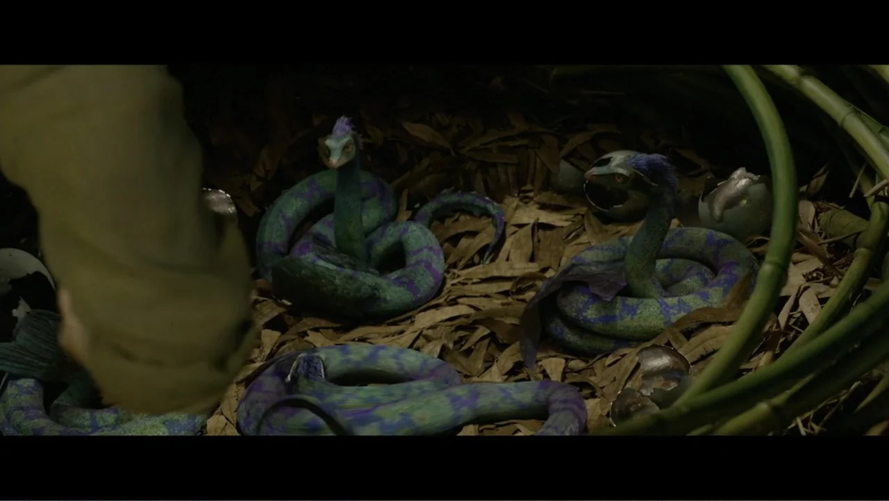 Fantastic Beasts: A Natural History (2022) movie still: medium — A nest composed of brown dried leaves holds three small, patterned dragon…