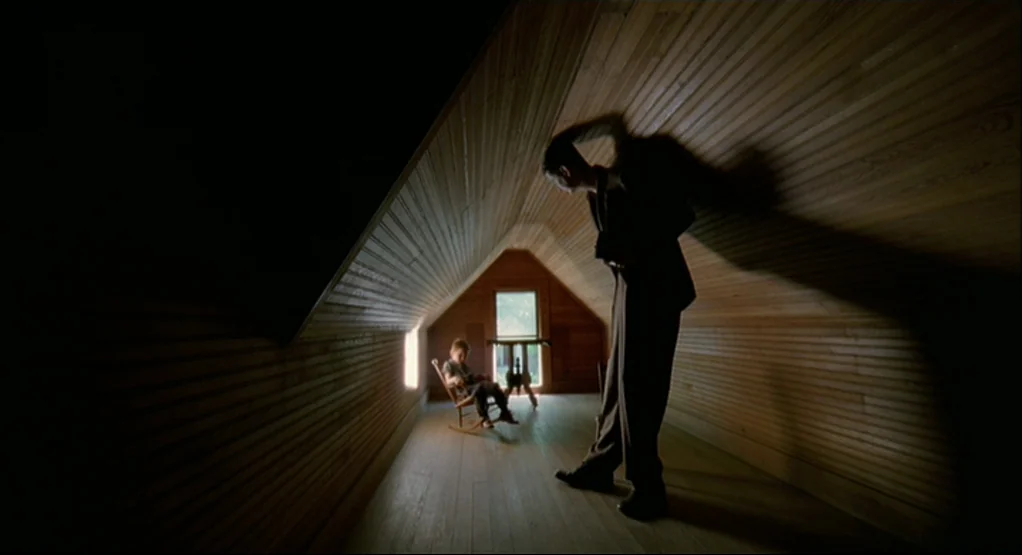 The Tree Of Life (2011) movie still: wide — A narrow attic with slanted wooden walls and light filtering through a small window. A man stands in the…