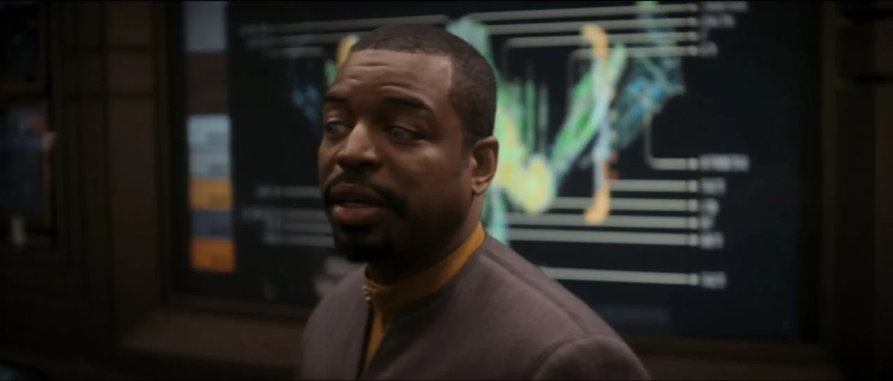 Star Trek: Nemesis (2002) movie still: medium — A dimly lit technical control station features a large glowing anatomical digital chart background.…