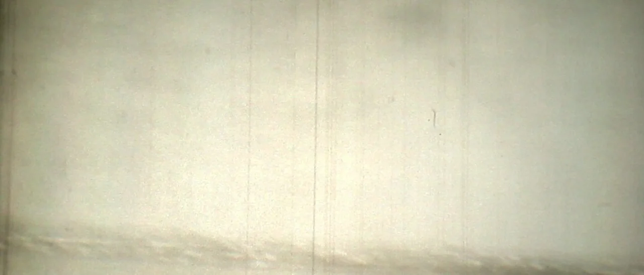Arabian Nights: Volume 3 The Enchanted One (2015) movie still: establishing — A flat, off-white surface textured with subtle vertical scratches and…