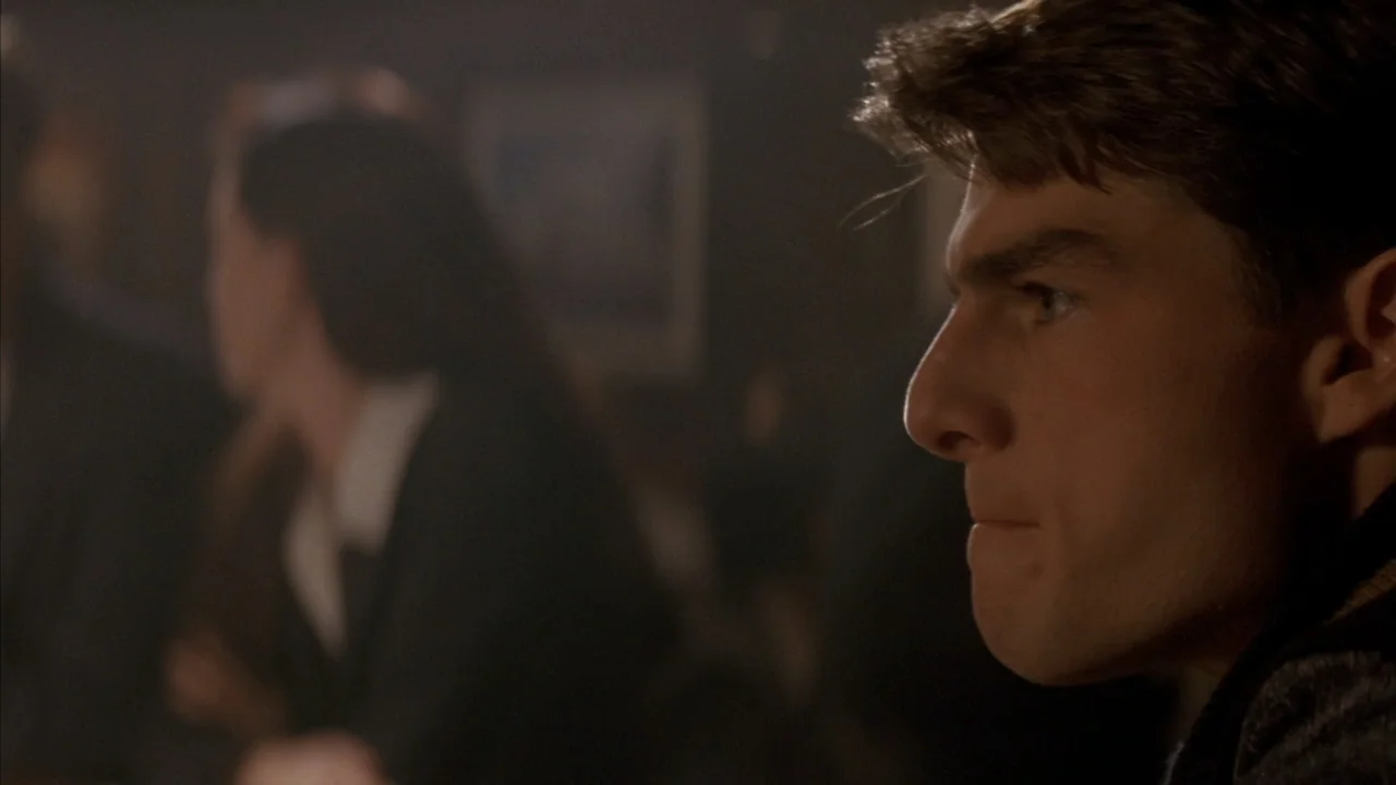 A Few Good Men (1992) movie still: closeup — A dimly lit bar interior features shadows and blurred background elements. A man in profile focuses his…