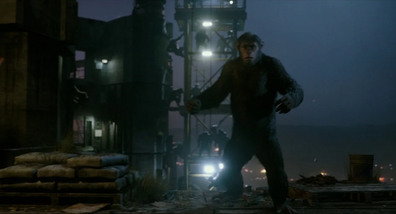 Dawn of the Planet of the Apes (2014) movie still: fullbody — An outdoor construction site at night with stacked cement bags and industrial…