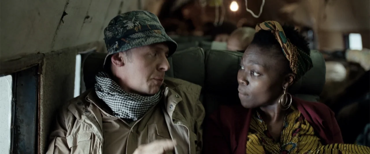 Hector and the Search for Happiness (2014) movie still: medium — The interior of a cramped, aged airplane cabin features padded seats and worn…