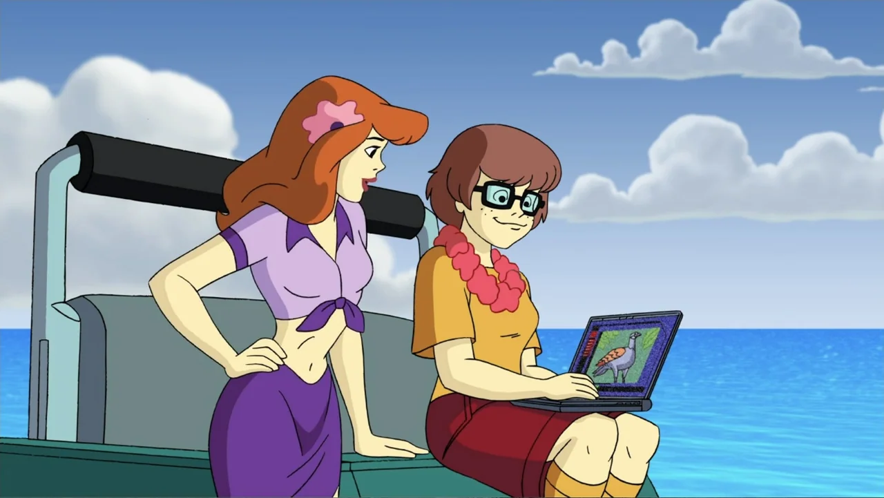 Aloha Scooby-Doo! (2005) movie still: medium — Two animated women sit on the rear deck of a boat against a blue sky. The seated woman types on a…