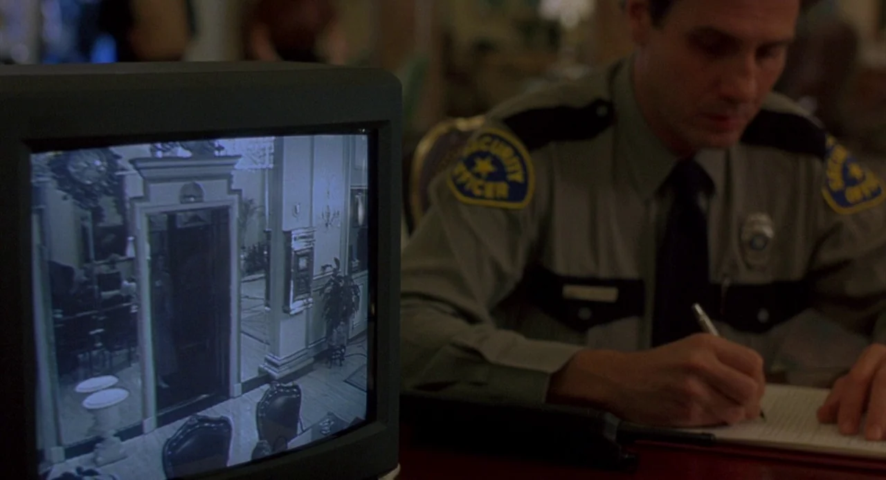 Candyman: Farewell to the Flesh (1995) movie still: medium — A dimly lit security office contains a monitor displaying a monochrome hotel hallway…