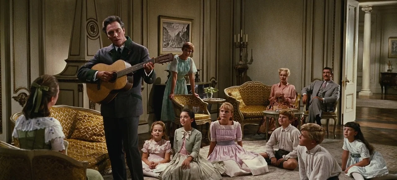 The Sound of Music (1965) movie still: wide — An opulent, high-ceilinged room features wood paneling and gilded furniture in a formal arrangement. A…
