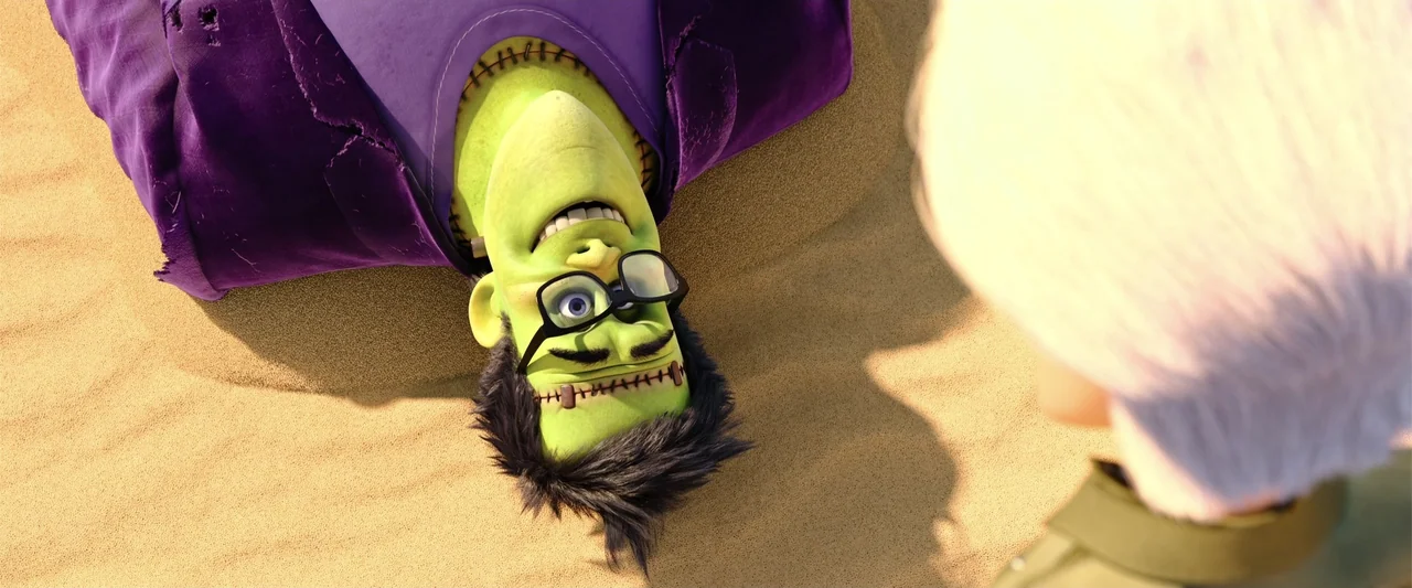 Happy Family (2018) movie still: medium — A green-skinned man with stitches lies on golden sand under bright daylight. Another person stands…