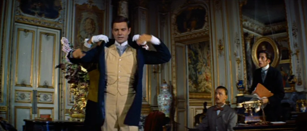 Gigi (1958) movie still: medium — An opulent, gold-trimmed room features neoclassical wall paneling and ornate floral decor. A man in formal wear…