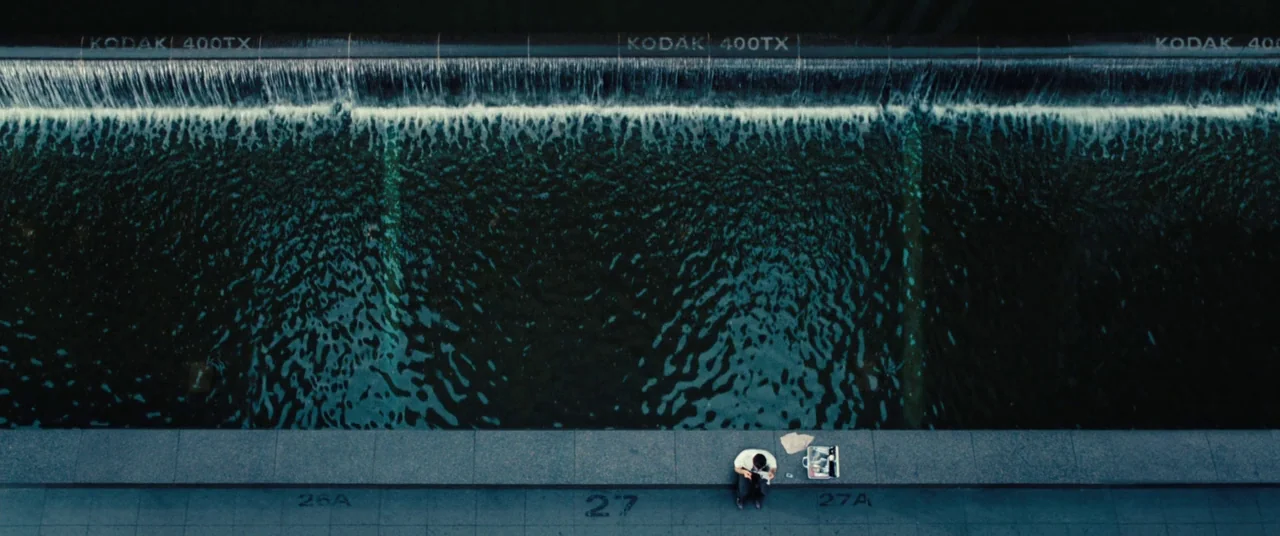 The Secret Life of Walter Mitty (2013) movie still: establishing — A dark concrete edge overlooks a large, rectangular water feature with a…