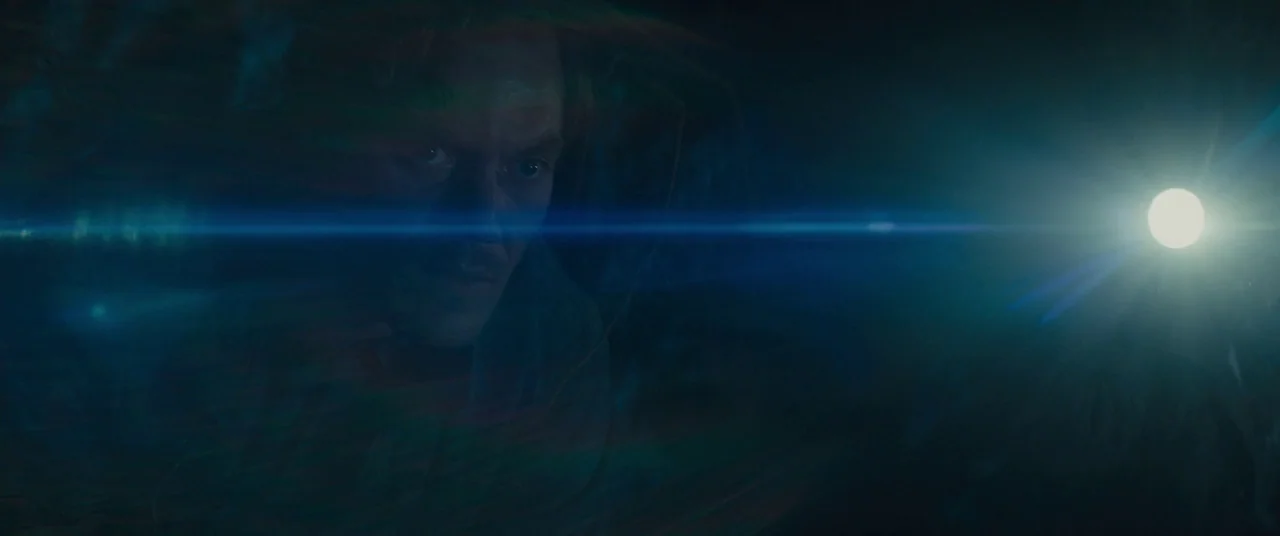 Midnight Special (2016) movie still: closeup — A man stands in a dark environment partially obscured by a lens flare. He looks toward a bright light…