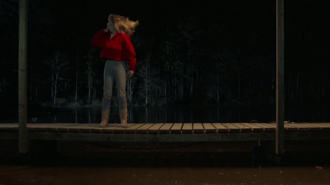 Friday the 13th Part VI: Jason Lives (1986) movie still: fullbody — A person stands on a wooden dock at night overlooking a dark lake. The…