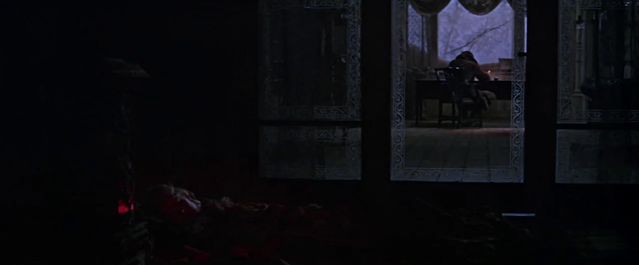 Doctor Zhivago (1965) movie still: wide — A dark study features a large window with intricate lace patterns looking onto night. A lone figure sits…