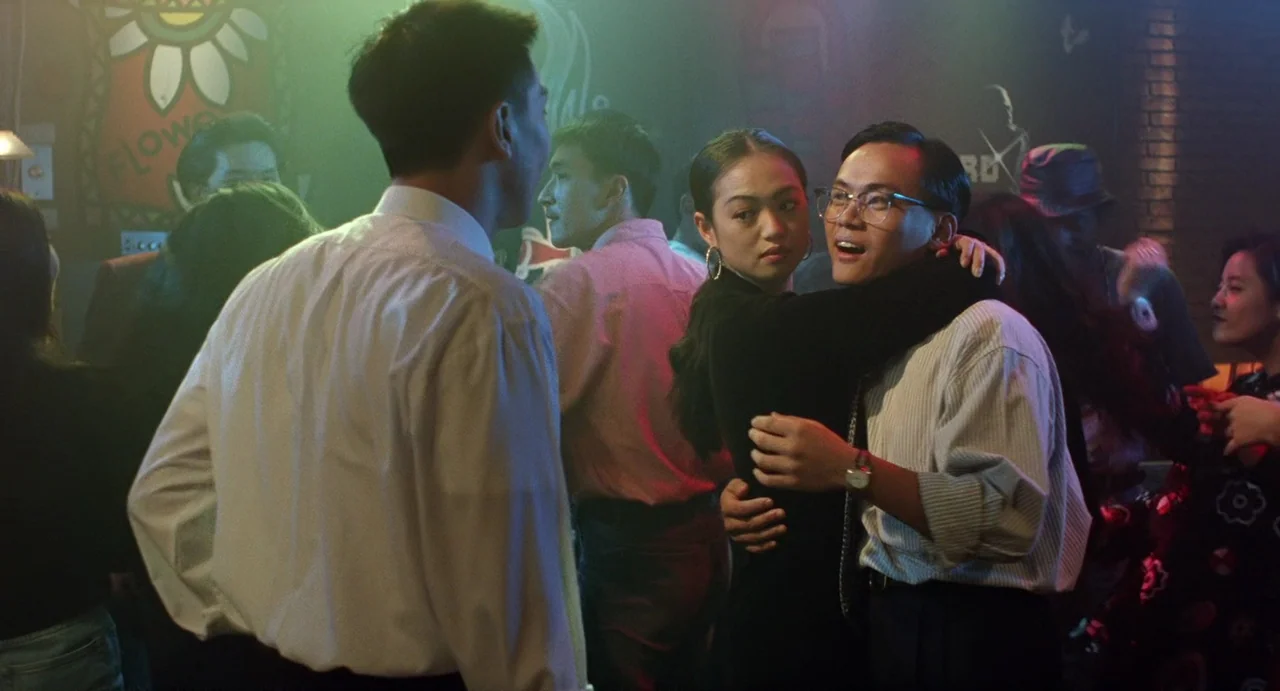 A Confucian Confusion (1994) movie still: medium — A crowded nightlife venue features dim, haze-filled air and various patrons in the background. A…