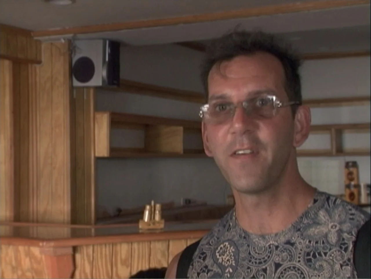 All Aboard! Rosie's Family Cruise (2006) movie still: medium — A man stands inside a bar with wood-paneled walls and a wooden bar top. The man faces…