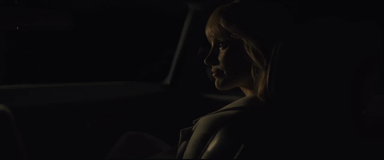 A Most Violent Year (2014) movie still: medium — The interior of a vehicle is dark with the exterior night hidden behind glass. A woman sits in the…