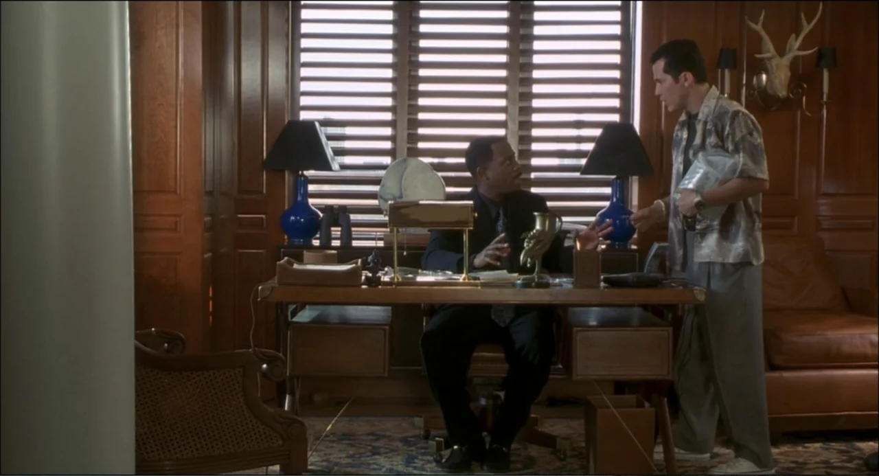 What's the Worst That Could Happen? (2001) movie still: medium — An executive office features wood-paneled walls and a desk positioned before large…