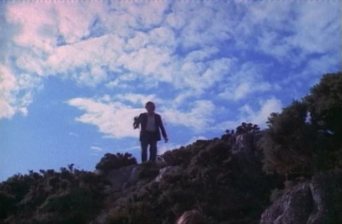 Quackser Fortune Has a Cousin in the Bronx (1970) movie still: wide — A high-altitude, craggy hilltop covered in low-lying green shrubs against a…