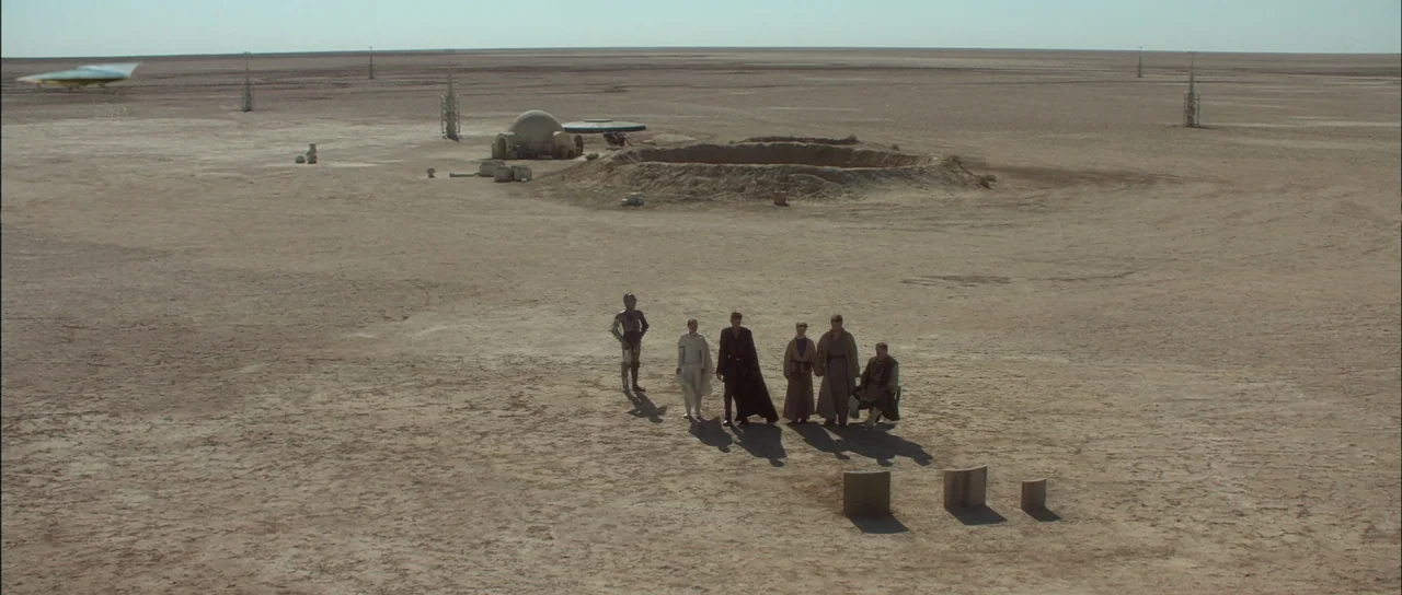 Star Wars: Episode II – Attack of the Clones (2002) movie still: wide — A vast, flat desert landscape stretches toward a distant, cloudless horizon…
