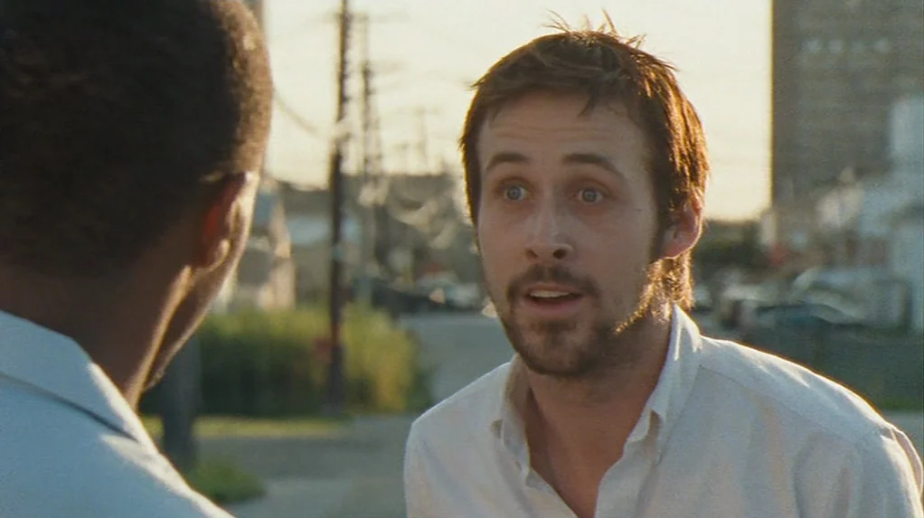Half Nelson (2006) movie still: medium — An outdoor city street at sunset with power lines and distant buildings visible. A man in a white shirt…