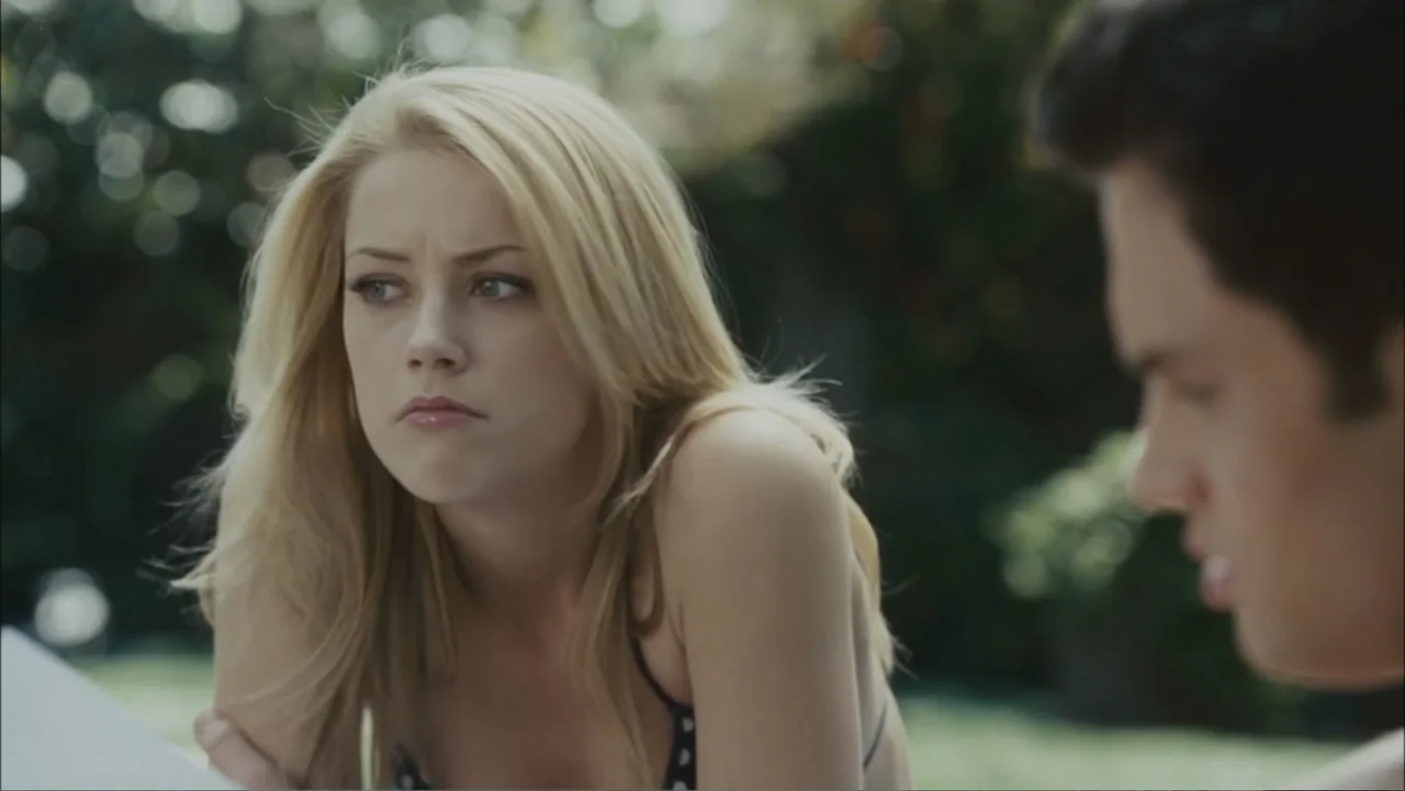The Stepfather (2009) movie still: medium — An outdoor swimming pool area with blurred green foliage in the background. A young woman in a bikini…
