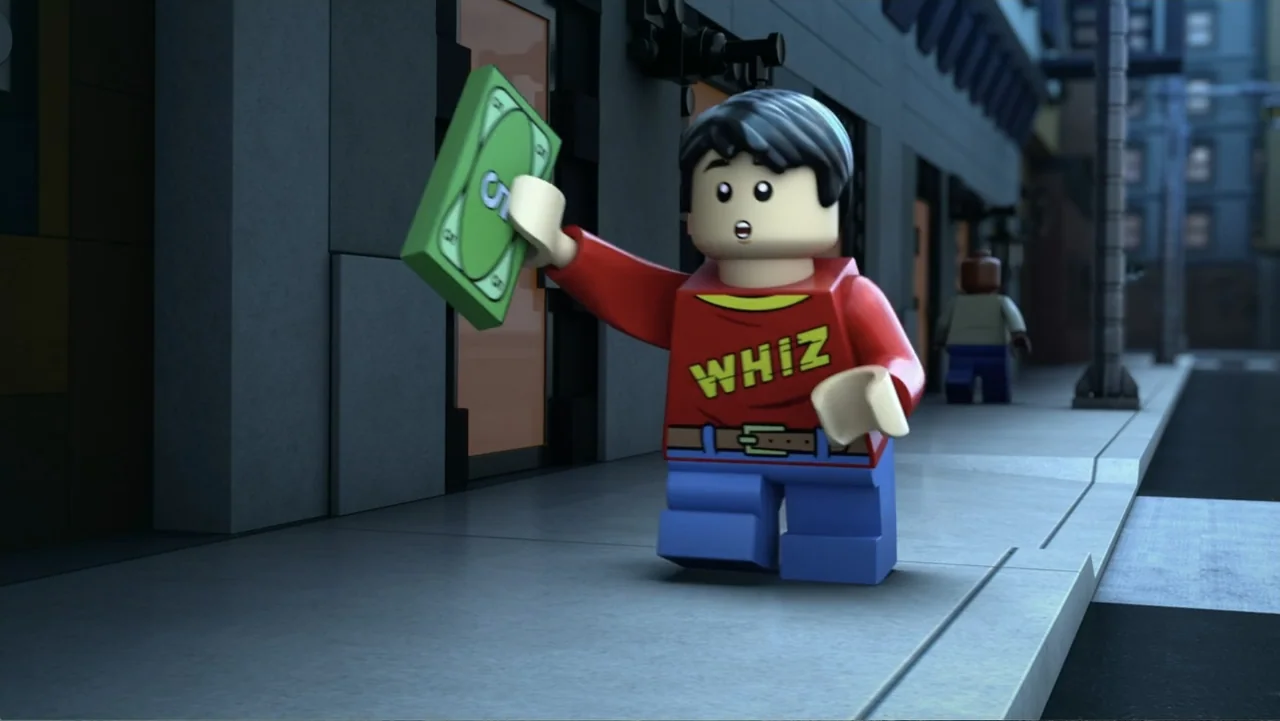 LEGO DC: Shazam! Magic and Monsters (2020) movie still: medium — A sidewalk made of gray plastic blocks features a stylized urban storefront…