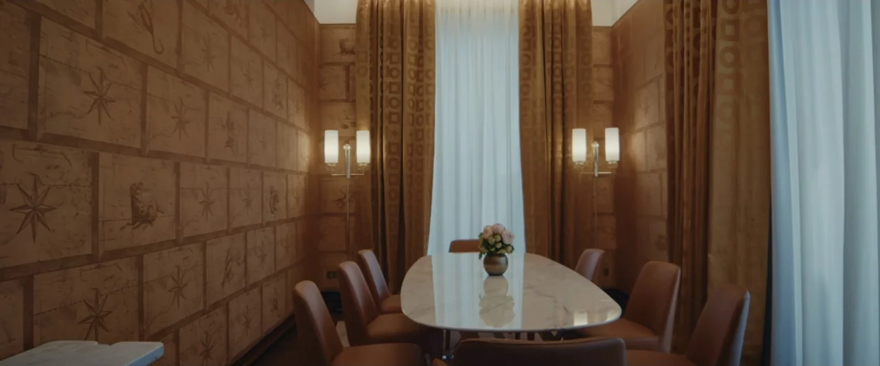 An emperor's jewel - The making of the Bulgari Hotel Roma (2024) movie still: wide — A refined meeting room features patterned tan wall paneling and…