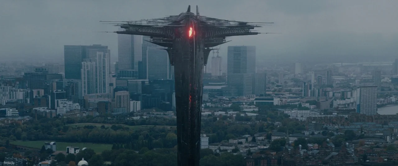 Thor: The Dark World (2013) movie still: establishing — A dark, monolithic alien spacecraft towers over a sprawling modern city under an overcast…