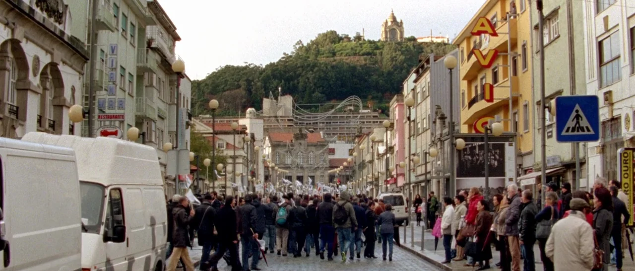 Arabian Nights: Volume 1 – The Restless One (2015) movie still: establishing — A European city street features multi-story buildings and a large…