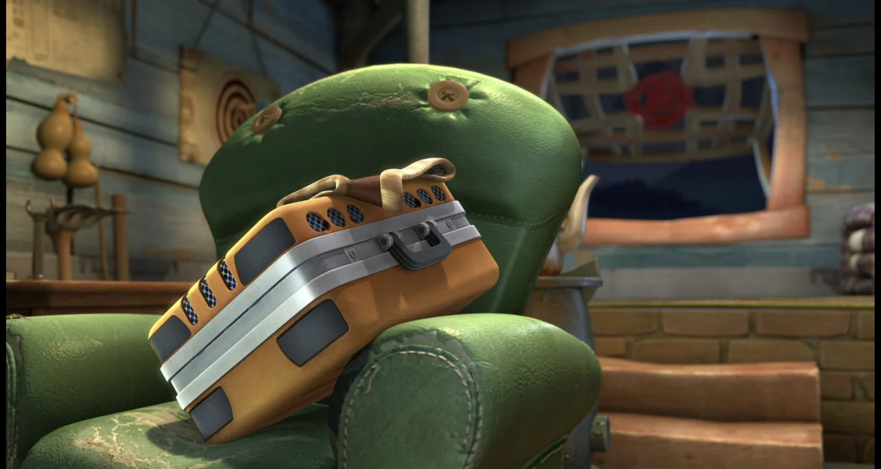 Boonie Bears: To the Rescue (2014) movie still: medium — A worn, button-tufted green armchair sits in a rustic room with wooden walls. An orange and…