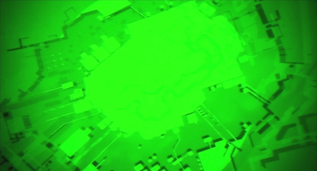 Ghost in the Shell (1995) movie still: establishing — An abstract, geometric pattern is displayed in a vibrant, monochromatic green light. The…