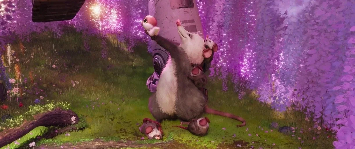 The Wild Robot (2024) movie still: medium — A grassy field is filled with vibrant purple flowering trees and scattered wildflowers. A mother opossum…