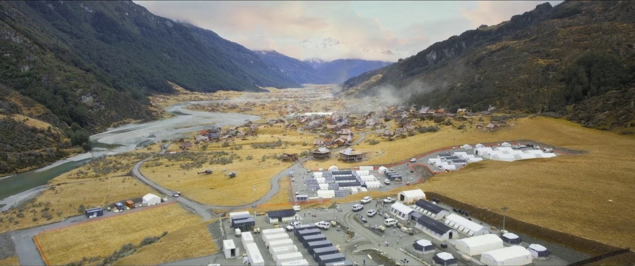 Mission: Impossible – Fallout (2018) movie still: establishing — A wide mountain valley features a winding river and a small cluster of buildings. A…