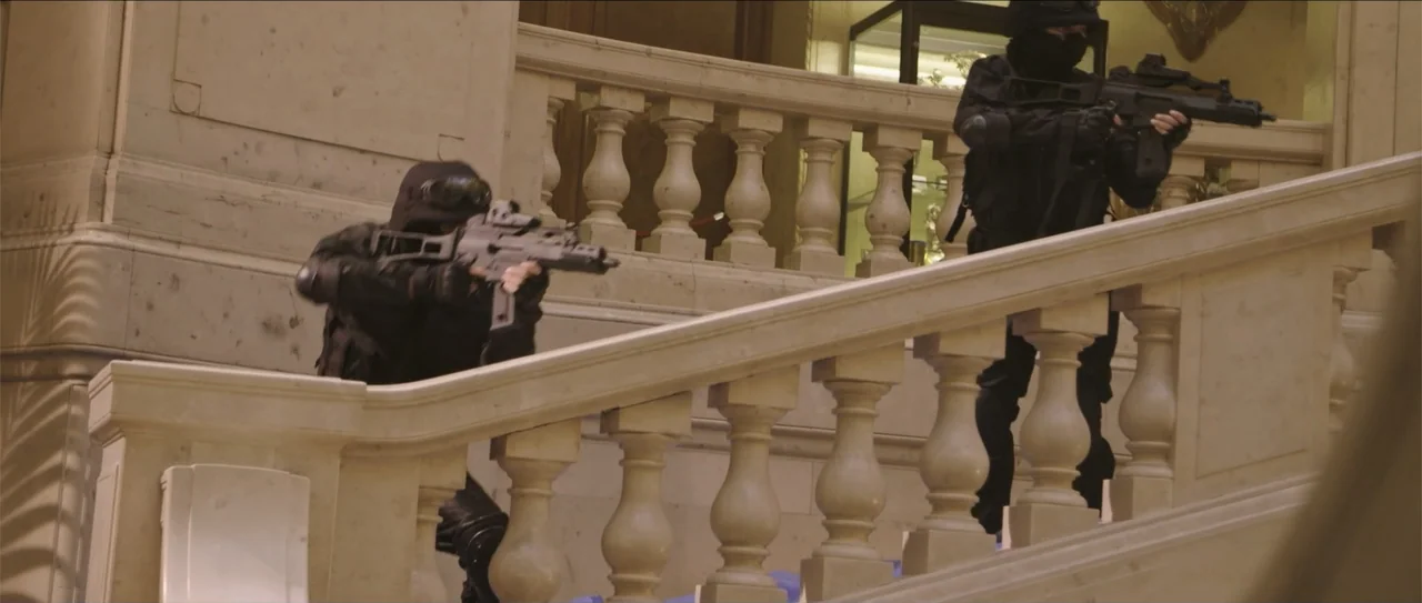 Django the Condemned (1965) movie still: medium — A stone staircase with classical balustrades features two tactical operators moving upward. The…