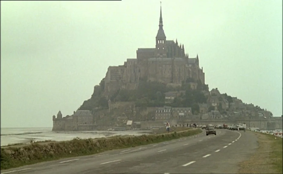 Pauline At the Beach (Pauline à la plage) (1983) movie still: establishing — A massive medieval abbey sits atop a craggy tidal island surrounded by…