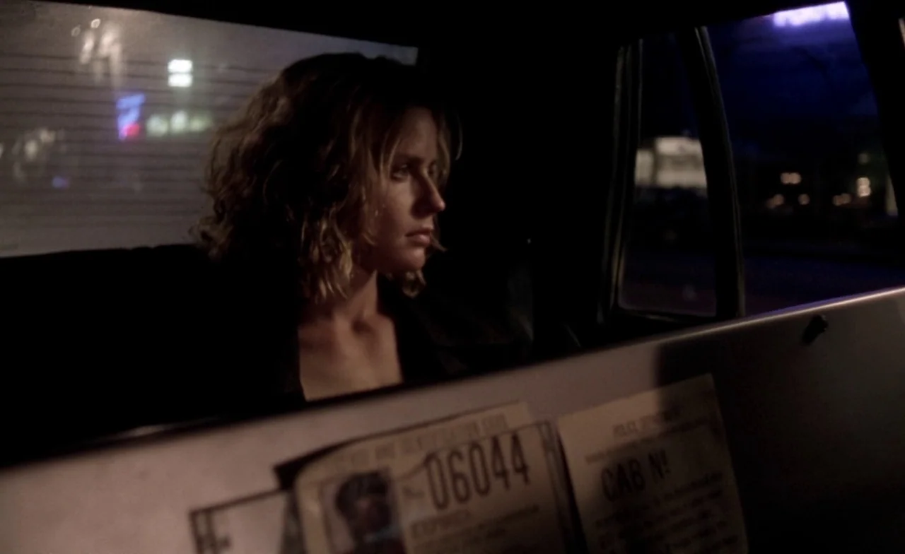 Leaving Las Vegas (1995) movie still: medium — The interior of a moving taxi at night with dark leather upholstery. A woman stares out the window…