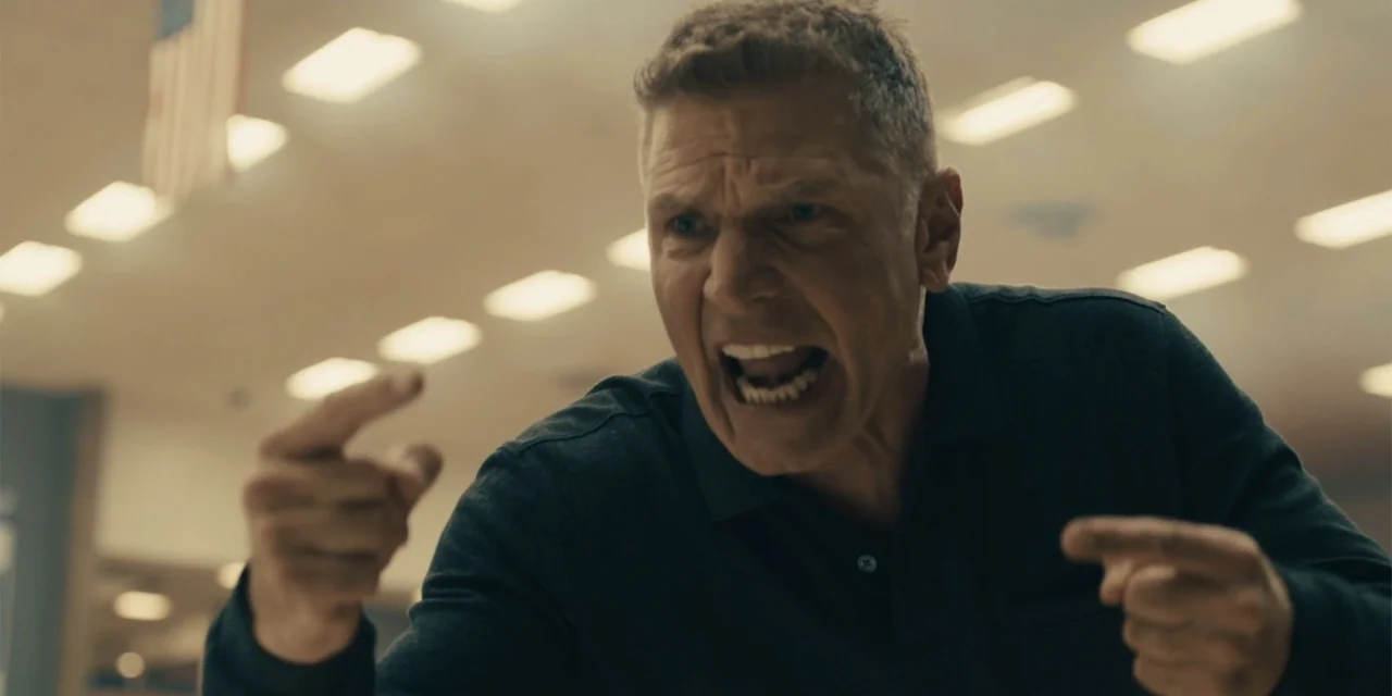 All Roads to Pearla (2019) movie still: closeup — An interior school hallway with white ceiling tiles and fluorescent lighting panels overhead. A…