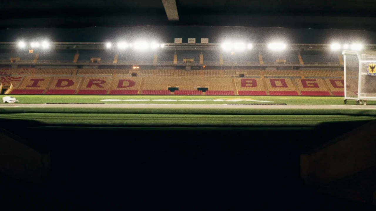An Affair: A Dangerous Sexual Play (2014) movie still: establishing — An empty soccer stadium at night with lit grandstands visible across the…