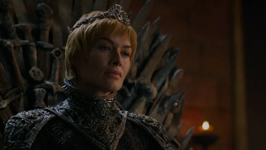 Game of Thrones (2017) movie still: medium — A dark stone chamber features a chair made from numerous upright iron swords. A blonde woman in ornate…