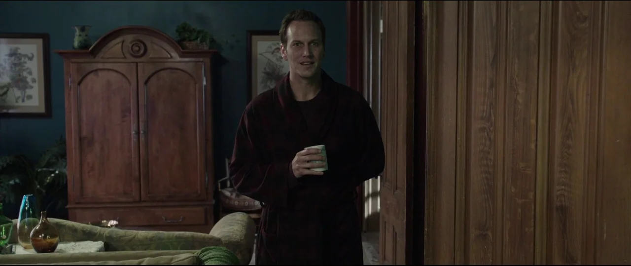Insidious: Chapter 2 (2013) movie still: medium — A residential interior features dark teal walls, wooden paneling, and an antique wooden wardrobe.…