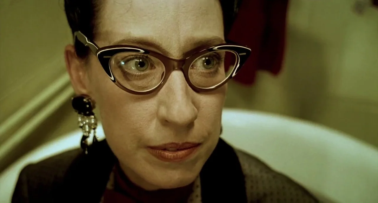 Delicatessen (1991) movie still: closeup — The interior of a white porcelain tub provides the backdrop for this close-up shot. A woman wearing…