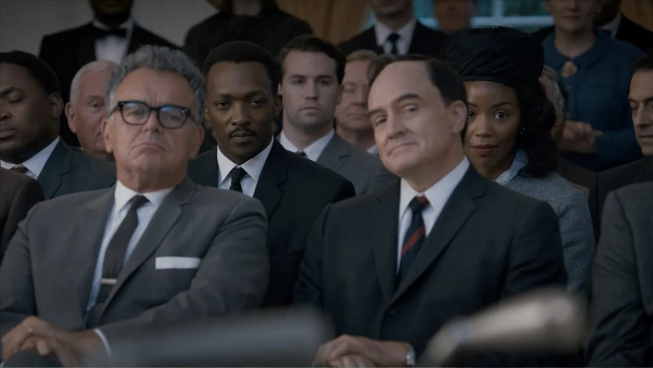 All the Way (2016) movie still: medium — A crowded formal event features rows of seated individuals in a professional setting. Several men in dark…