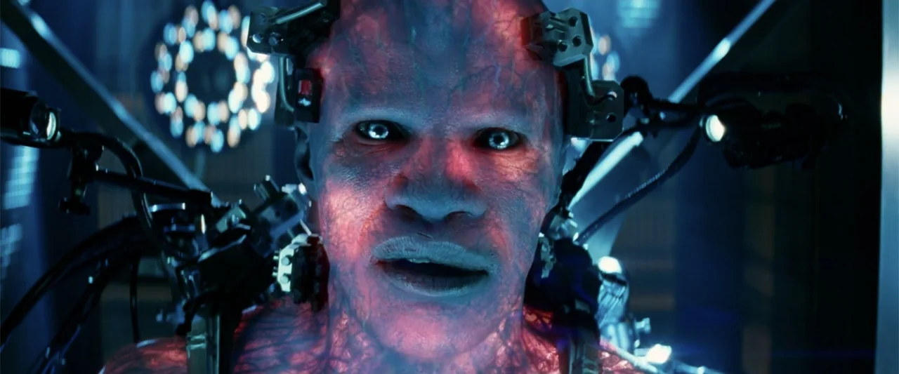 The Amazing Spider-Man 2 (2014) movie still: closeup — A high-tech laboratory contains metallic medical equipment surrounding a man integrated with…